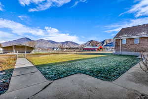 Fenced backyard with a mountain view