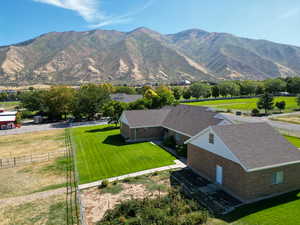 Aerial view of property and surrounding area featuring a mountain backdrop