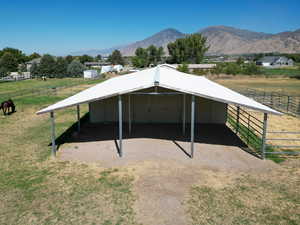 View of outdoor structure with a rural view, a mountain view, an exterior structure, and a carport