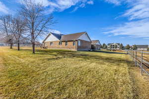 View of side of property with brick siding and roof with shingles
