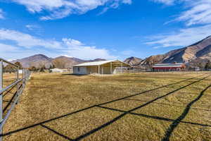 View of yard featuring a mountain view and an outdoor structure