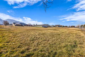View of yard featuring an outbuilding, a view of countryside, and a mountain view