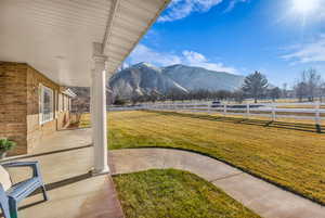 Fenced backyard featuring a mountain view