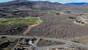 Aerial overview of property's location featuring property parcel outlined and a mountain backdrop