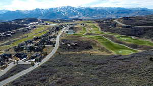 Aerial view of a mountain backdrop and a local golf course