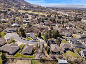 Aerial view of property's location with nearby suburban area and a mountain backdrop
