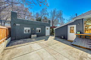 Back of house with stucco siding and a patio