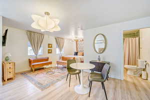 Sitting room with light wood finished floors and a chandelier