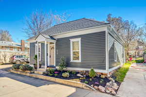 View of front facade with roof with shingles