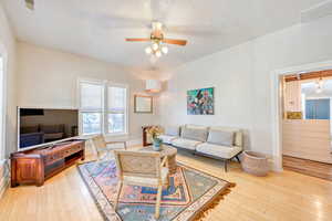 Living room featuring ceiling fan and light wood-type flooring