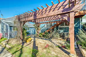 Rear view of property with a pergola