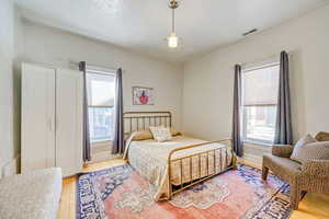 Bedroom featuring light wood-style floors and baseboards
