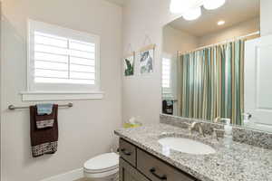 Bathroom with vanity and a shower with curtain