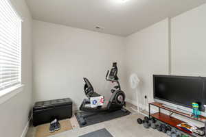 Exercise room featuring carpet flooring and baseboards