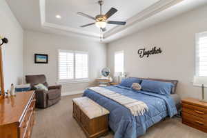 Carpeted bedroom featuring a ceiling fan and recessed lighting