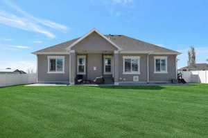 Back of property with a patio, stucco siding, and a shingled roof