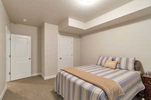 Bedroom featuring carpet floors and baseboards