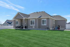 Rear view of property with a patio area, stucco siding, and roof with shingles