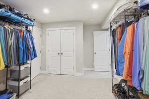 Walk in closet with light carpet