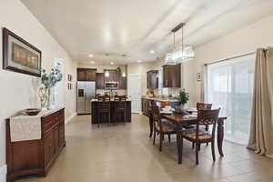 Dining space with recessed lighting and baseboards