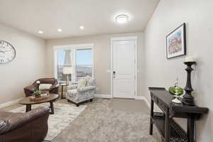 Sitting room featuring light carpet and recessed lighting