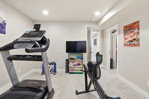 Workout area featuring light carpet and recessed lighting