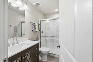 Bathroom featuring vanity, a shower stall, and recessed lighting