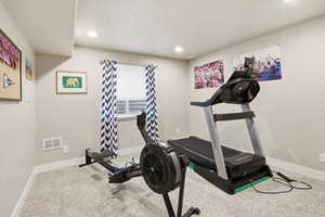 Workout room featuring light carpet and recessed lighting
