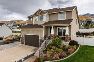 Craftsman inspired home with a mountain view, roof with shingles, concrete driveway, and a residential view