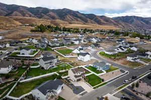 Aerial view of property's location featuring a mountain backdrop and nearby suburban area