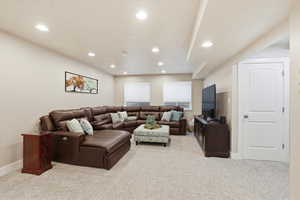 Living area featuring light carpet and recessed lighting
