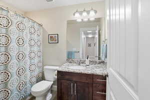 Bathroom with vanity and curtained shower