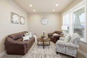 Carpeted living room with recessed lighting