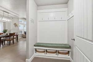 Mudroom featuring a textured ceiling and light tile patterned floors