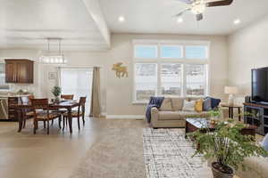 Living room with ceiling fan, recessed lighting, and light tile patterned flooring