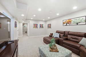 Living area featuring light carpet and recessed lighting