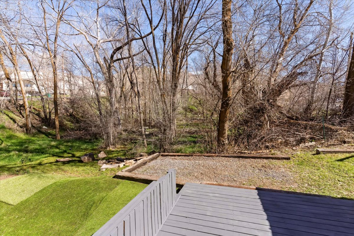 View of turf with a deck and RV parking.