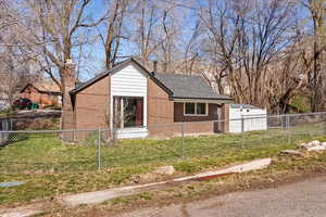 Bungalow-style home with a chimney and a new shingled roof (2024)