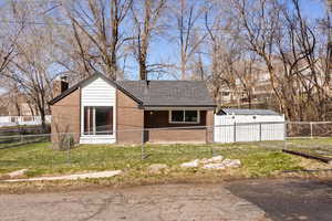 View of front of house with roof with shingles and a chimney