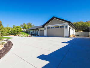 View of front of property featuring an attached garage and concrete driveway
