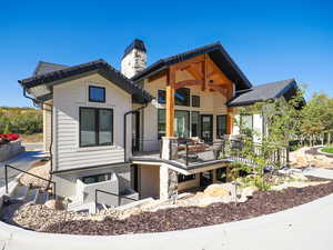 Rear view of property featuring a chimney