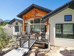 Rear view of property with a wooden deck