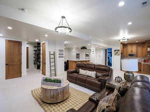 Living area featuring recessed lighting and light carpet