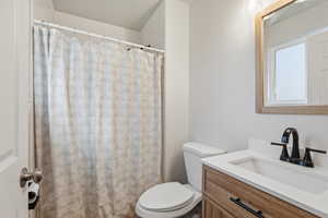 Full bathroom with vanity and curtained shower