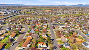 Aerial view of property's location with nearby suburban area and mountains