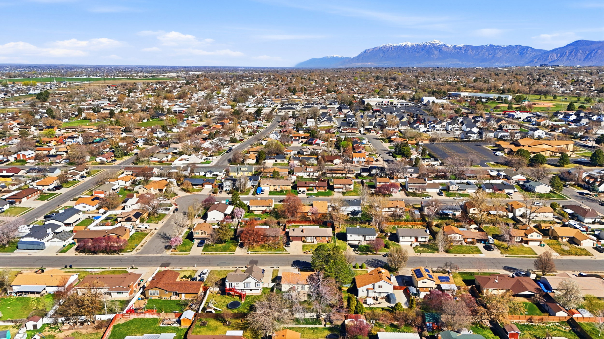 Aerial perspective of suburban area featuring a mountainous background