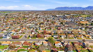 Aerial perspective of suburban area featuring a mountainous background
