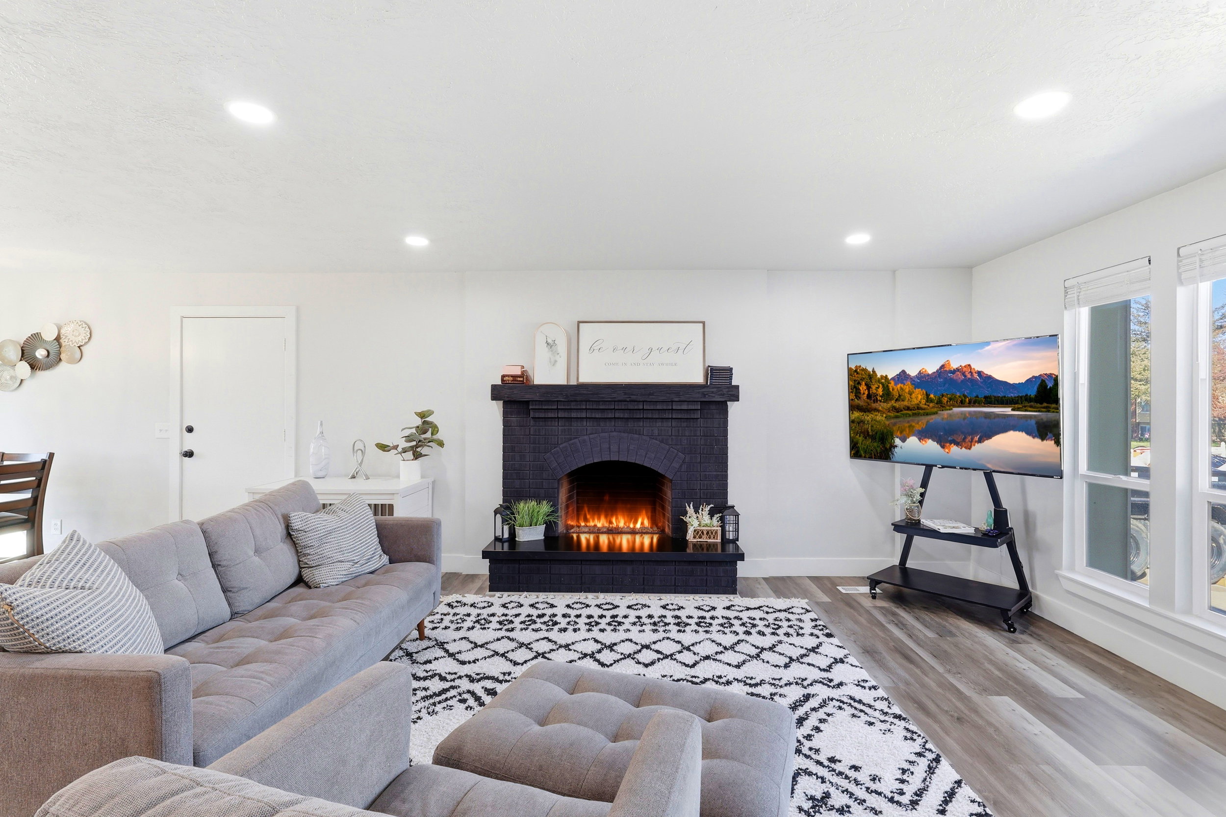 Living room featuring a fireplace, light wood-style flooring, and recessed lighting