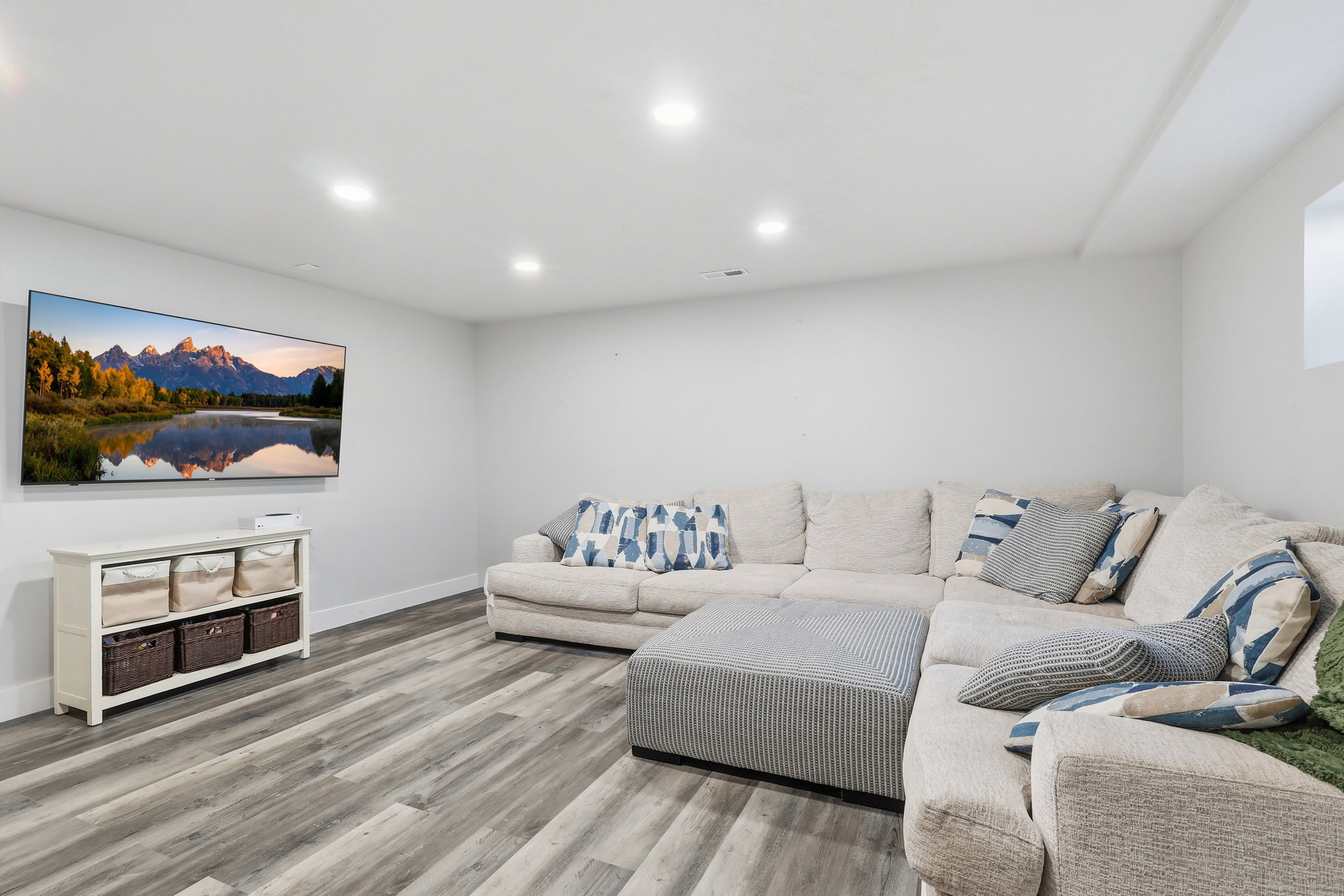 Living room with light wood finished floors and recessed lighting