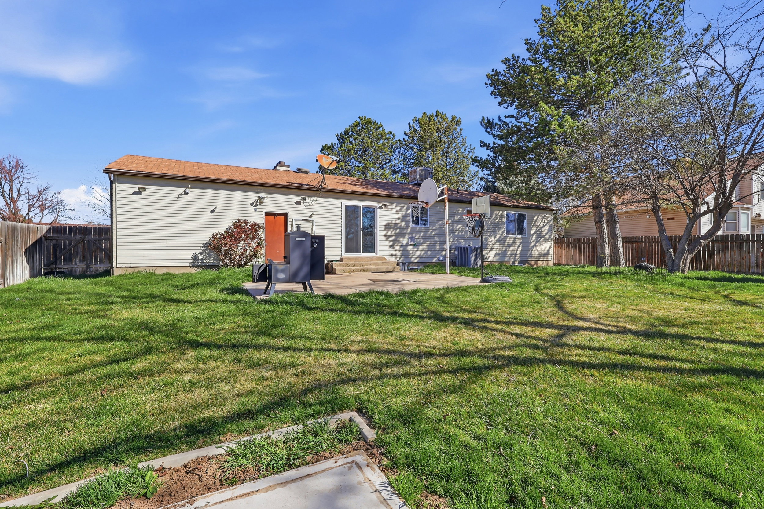Rear view of house featuring a fenced backyard and a patio area